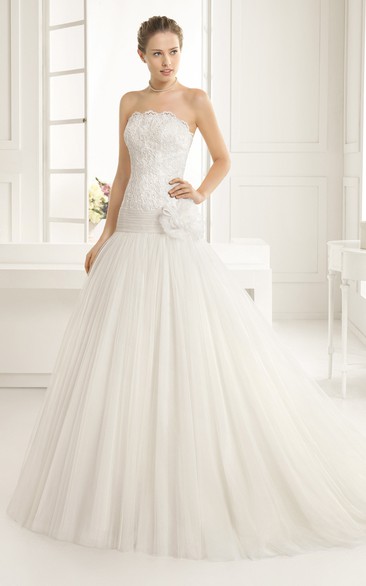 Scalloped Strapless Gown With Dropped Waistline And Flower